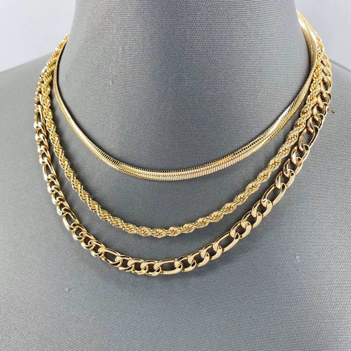 Gold Finish Multi Layered Necklace With Herringbone, Rope And Figaro Link Chain