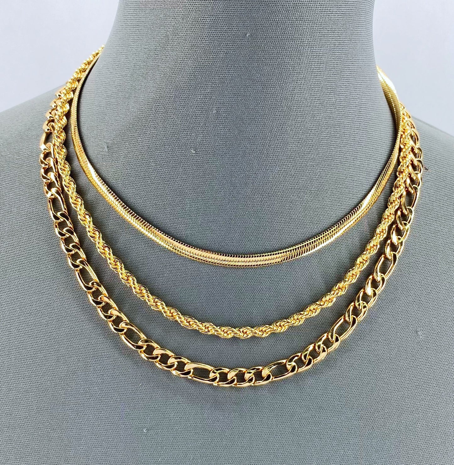 Gold Finish Multi Layered Necklace With Herringbone, Rope And Figaro Link Chain
